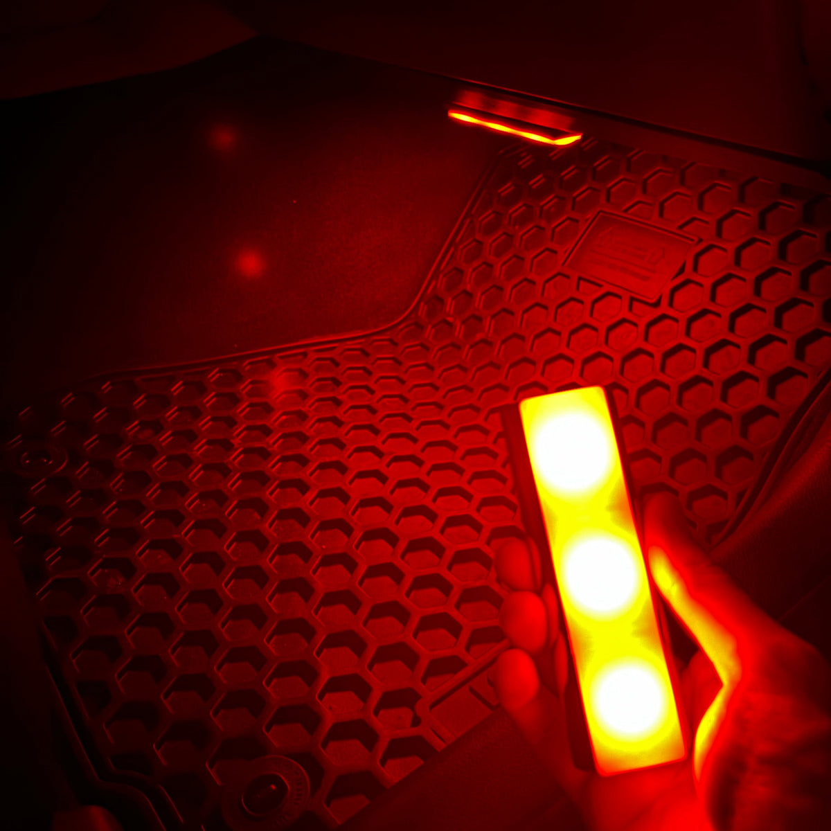 Onevzn PRO wireless LEDs in red mode illuminating car footwell